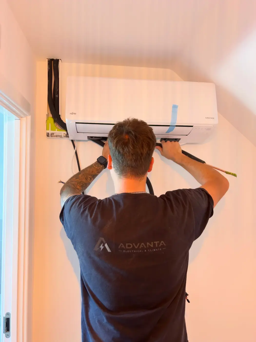 Advanta engineer installing a Fujitsu air-conditioning system
