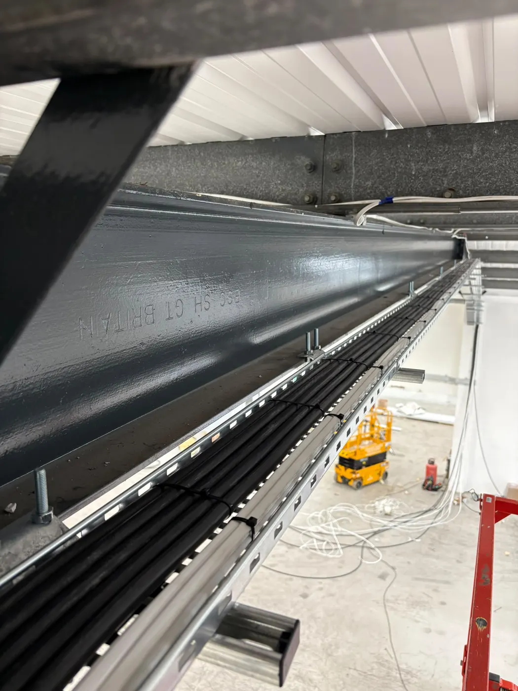 Cable tray and containment on a steel beam during a fit-out